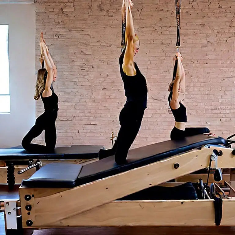 Three women performing pilates exercises on reformer machines with suspension straps